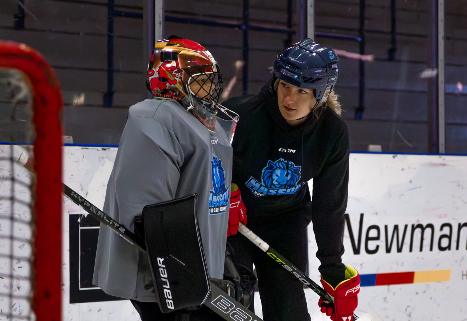Taylor coaching a goalie on the ice