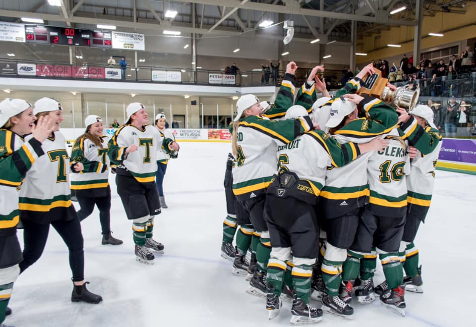 Hockey team celebrating a championship win on the ice